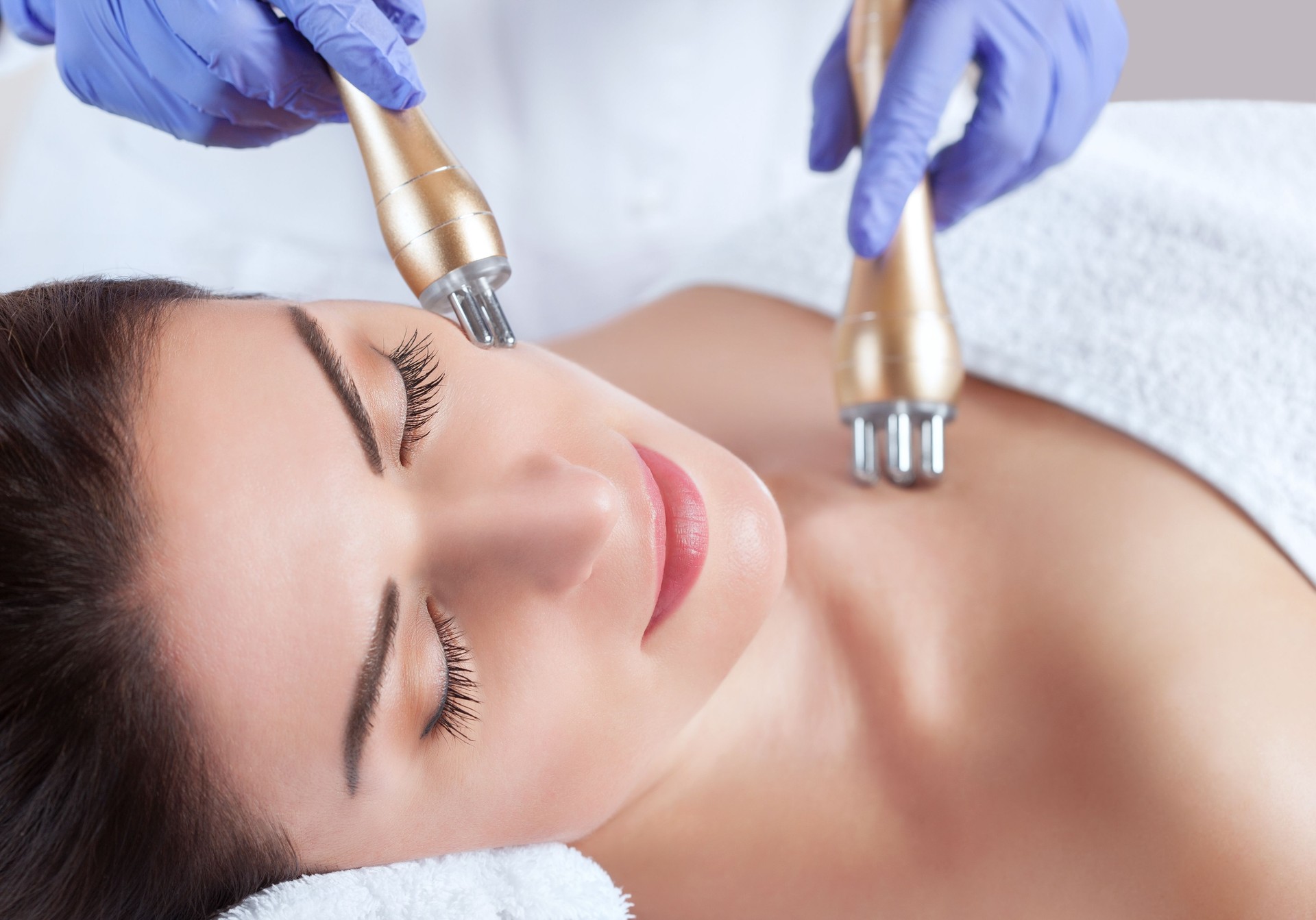 Portrait of woman getting rf-lifting on face and neck.