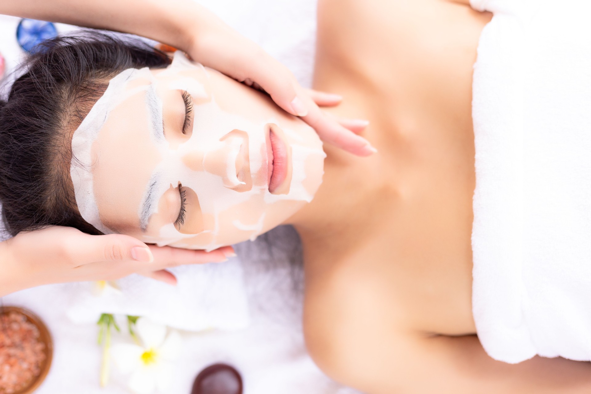 Massager massage face and use collagen mask put on her face for rejuvenation